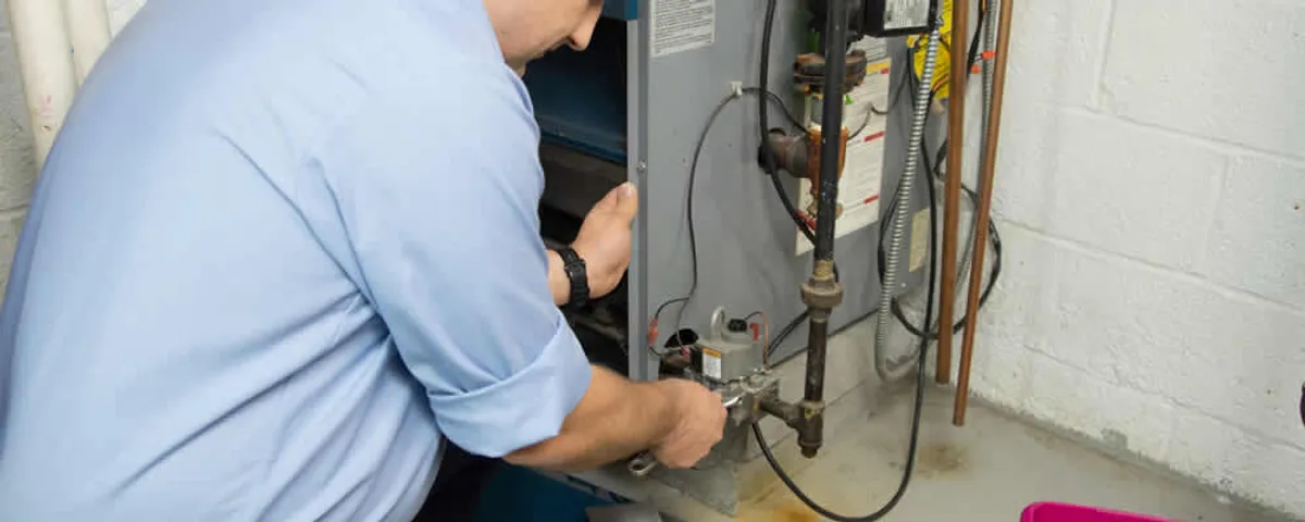 Furnace repair technician inspecting and servicing a home heating system in Cherry Hill, NJ